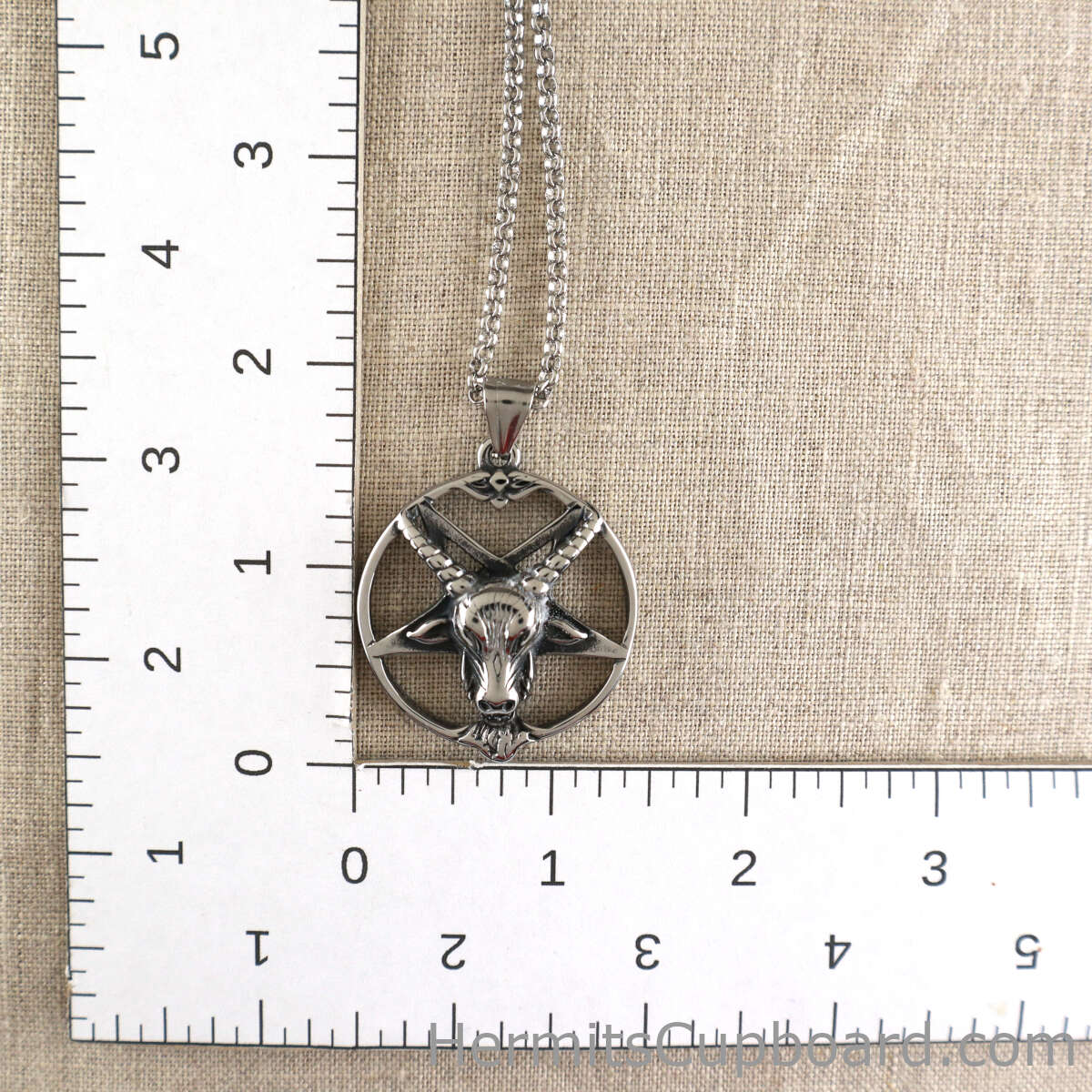 Satanist Inverted Baphomet Pentagram necklace next to ruler