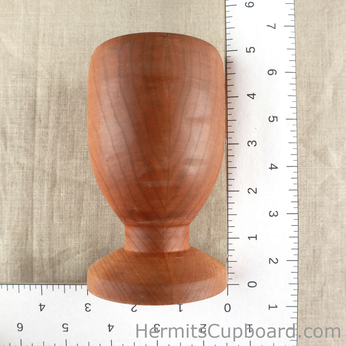 wood altar cup next to a ruler