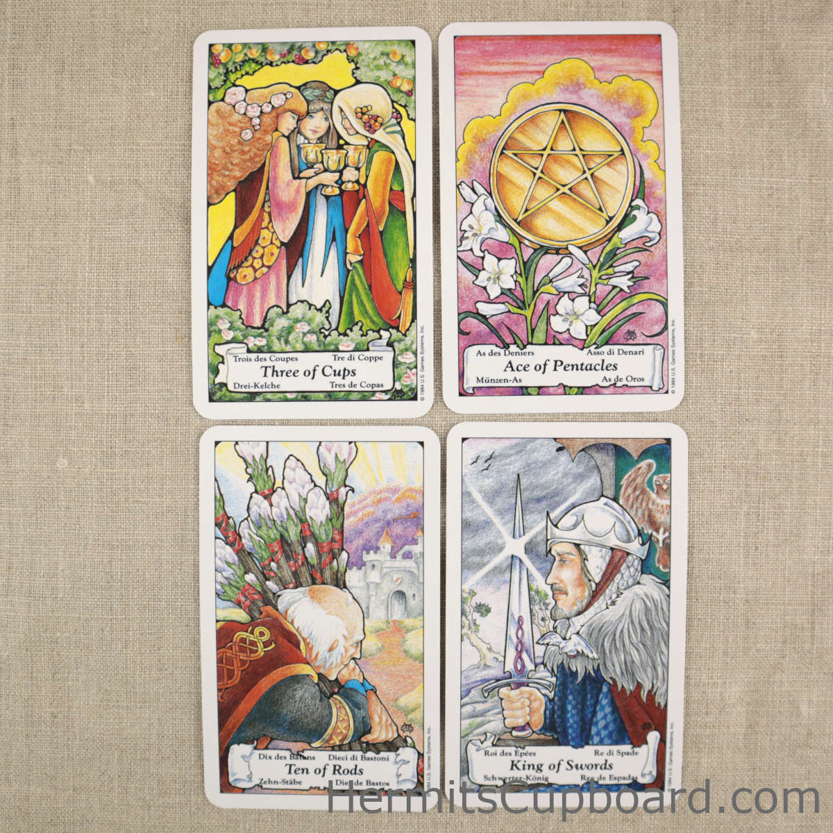 Hanson-Roberts Tarot cards, three of cups, ace of pentacles, ten of rods, and king of swords
