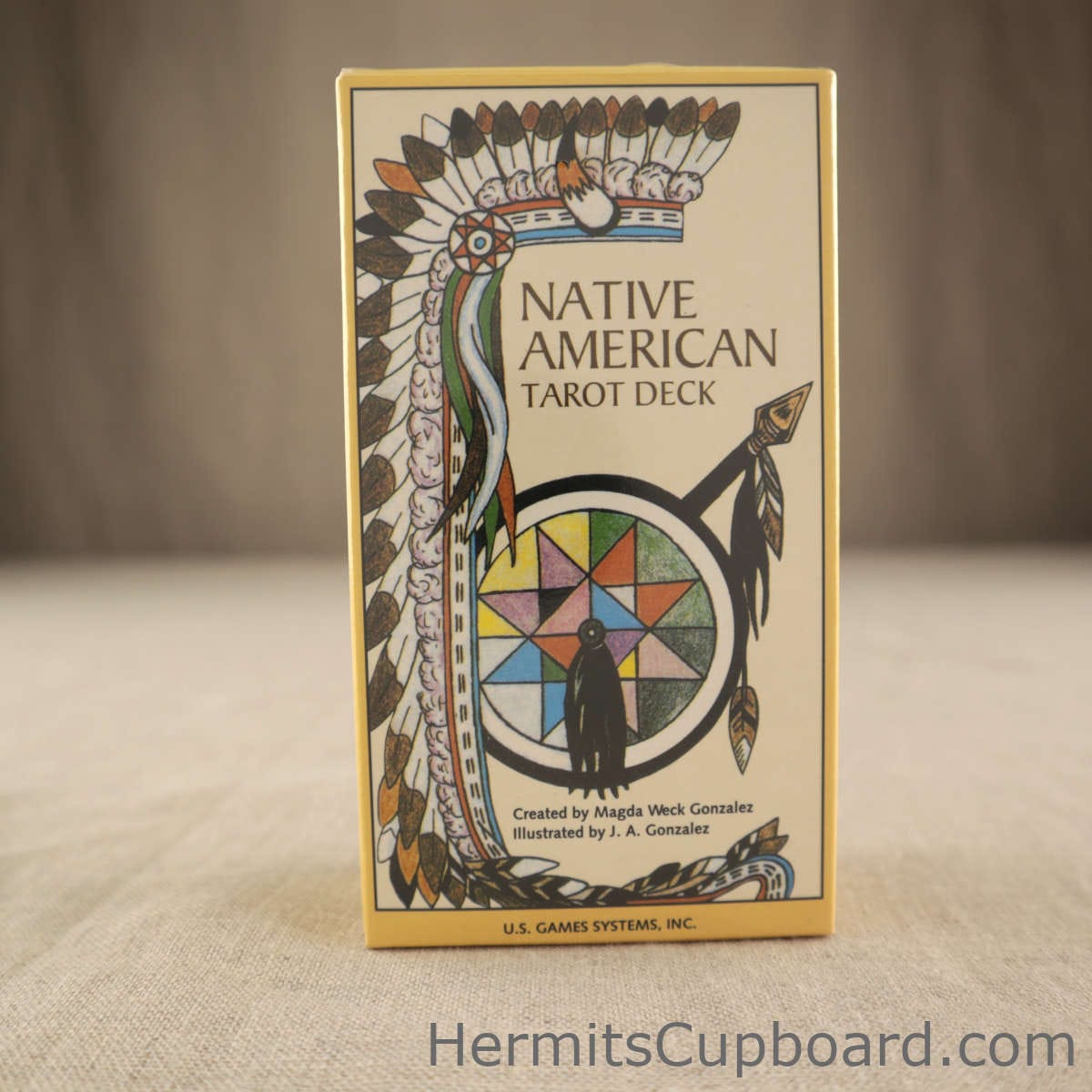 Native American Tarot deck front of box with a spirit wheel center bottom and a native headdress decending from the top down the left side