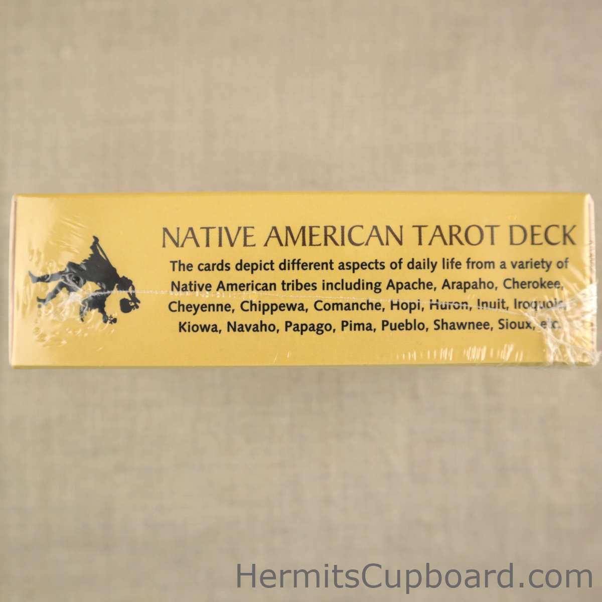 Native American Tarot deck side of box whch states the cards depict differnt aspects of daily life from a variety of native american tribes including Apache, Atapaho, Cherokee, Cheyenne, Chippewa, Hopi, Huron, Unuit, Iroquois, Kiowa, Navaho, Papago, Pima, Pueblo, Shawnee, Sioux, etc.