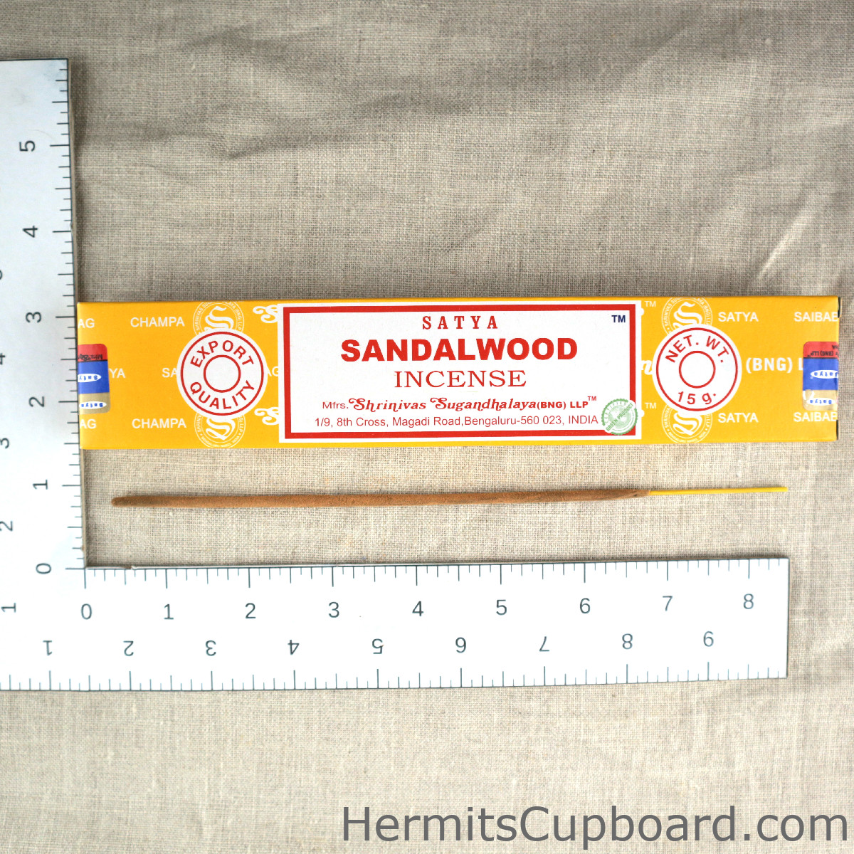 Satya Nag Champa Sandalwood Incense box with incense stick next to ruler for size comparison